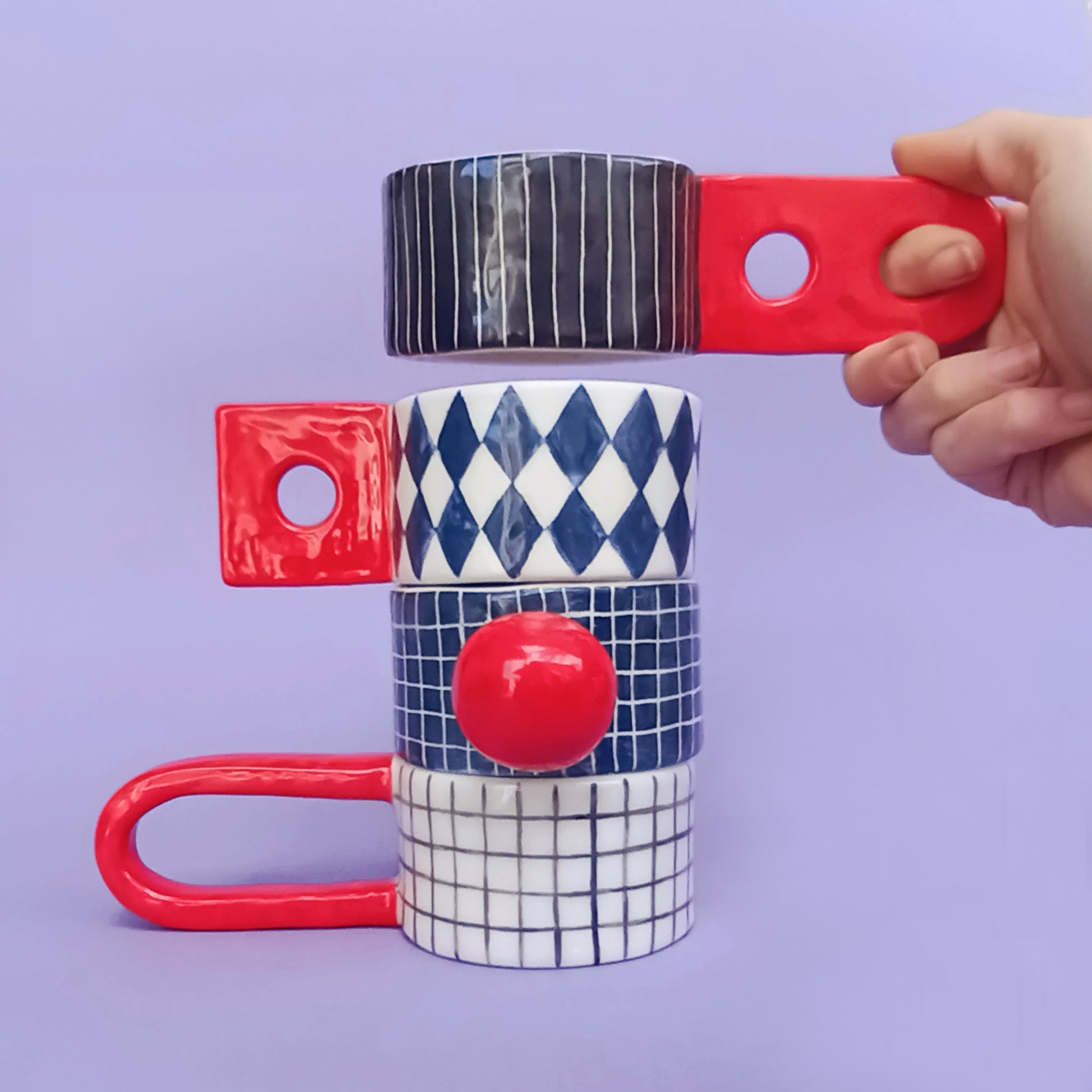 Graphic Cups lined up showing all four pattern variations – diamond, stripes, grid, hand-painted earthenware, designed by Siamese Twin Studio
