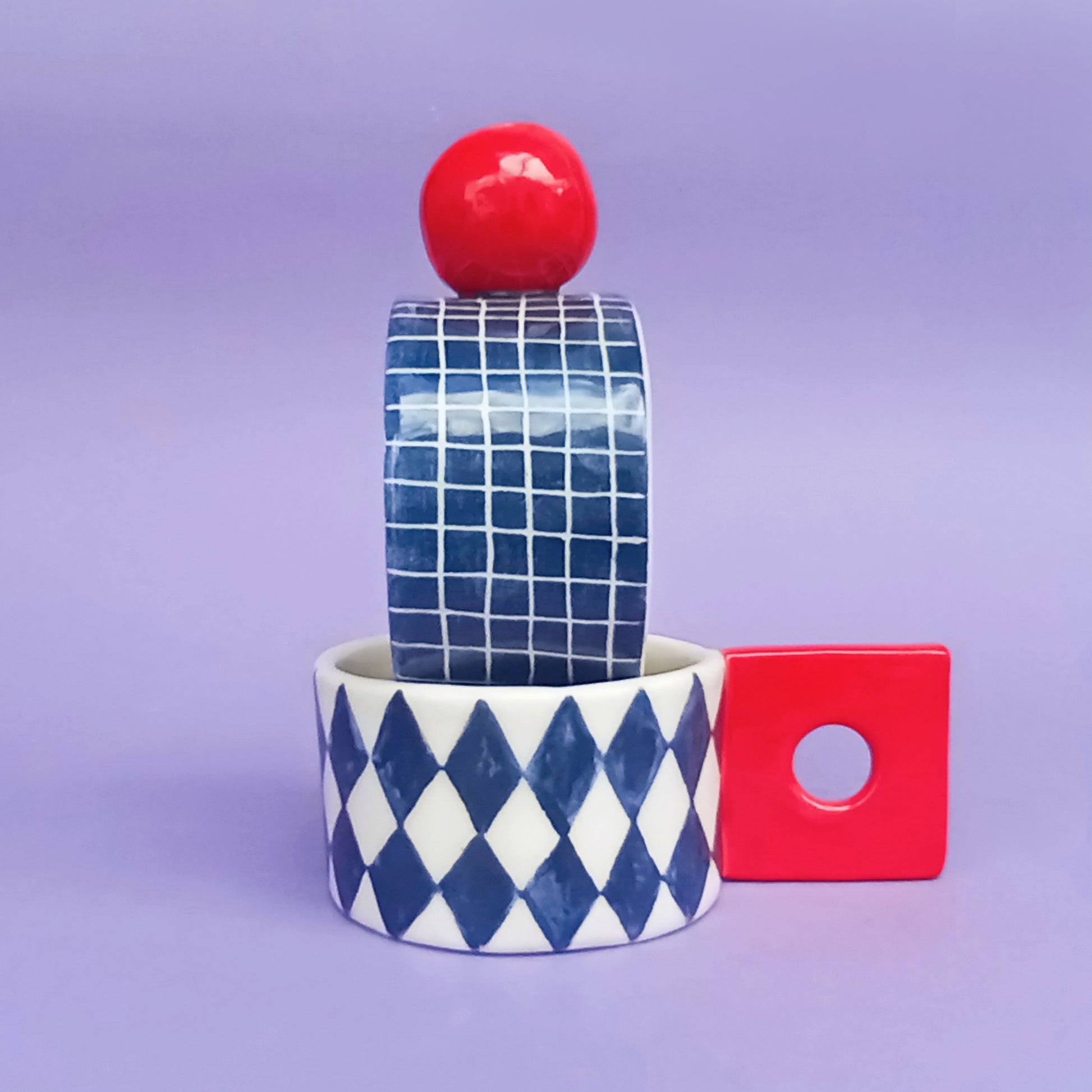 Graphic Cups collection – four hand-painted ceramic cups with bold geometric patterns in red, cobalt, black and white, by Siamese Twin Studio
